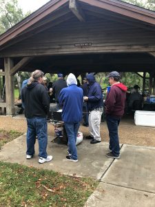 Floridians hover around hot grill to stay warm in the damp 60deg weather!